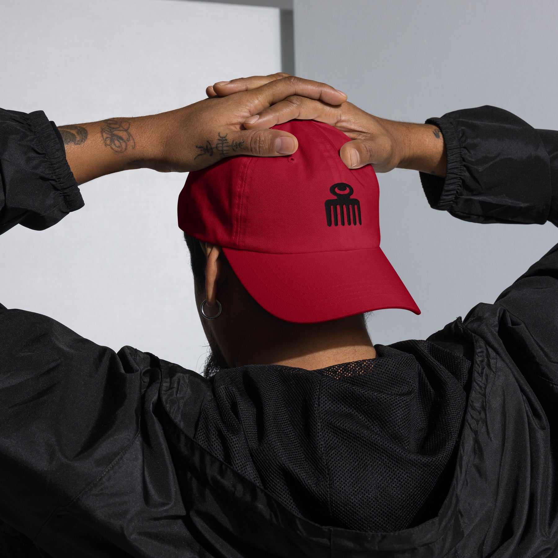 Urban model wearing Guardfashions Cherry Red Afro Comb embroidered cap.
